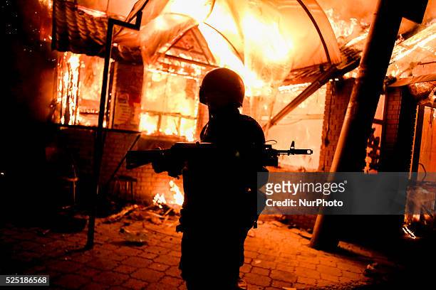 Separatist soldier in front of a show destroy during the night by a heavy artillery shoot from the ukrainian army, on May 22, 2014.