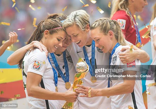 Alex Morgan , Lauren Holiday, Abby Wambach, and Whitney Engen of team USA celebrate with the World Cup trophy after their victory during 2015 women's...