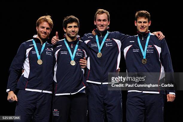 Laurence Halsted, Edward Jefferies, Jamie Kenber and Richard Kruse pose with their gold medals after winning the Men's Foil Team Event at the Fencing...
