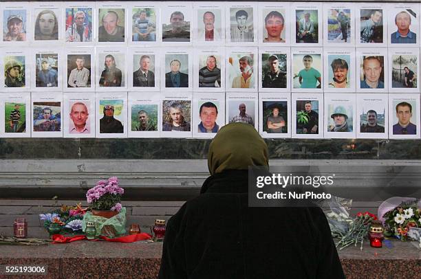Woman watches the portraits of the &quot;Heavenly Hundred&quot;. Ukrainians celebrates the 1st anniversary of the &quot;Revolution of Dignity&quot;...
