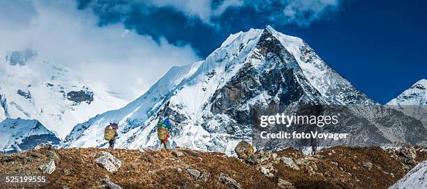 sherpa porters carrying baskets towards island peak himalaya mountains nepal - khumbu stockfoto's en -beelden