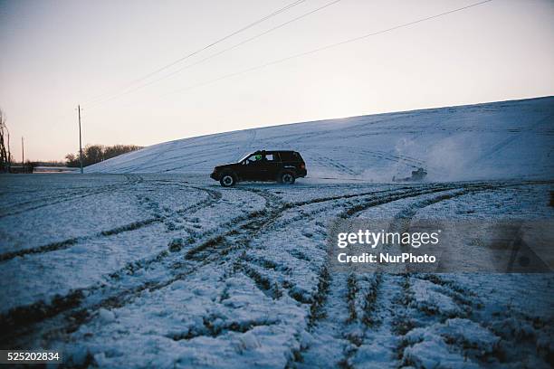 Young boy is seen being pulled behind an SUV truck through the snow, Lima, Ohio and the local area received about an inch of snow over night January...