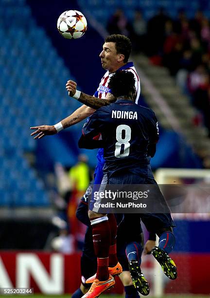 Atletico de Madrid's Croatian forward Mario Mandzukic and Olympiacos Congolese midfielder Delvin N'Dinga during the Champions League 2014/15 match...