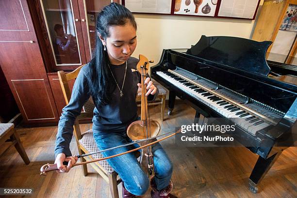 Student plays Kyl Kajak, traditional Kyrgyz bow instrument, during class of authentic Kyrgyz musical instruments headed by Abdykadyr Belekov in...
