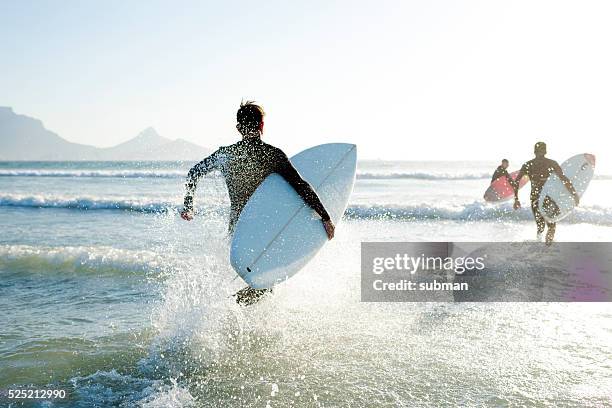 fun times with my friends - surfer wetsuit stock pictures, royalty-free photos & images