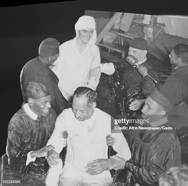 African-American Christian evangelist, faith healer, television personality and entrepreneur Lightfoot Solomon Michaux and converts during a baptism,...