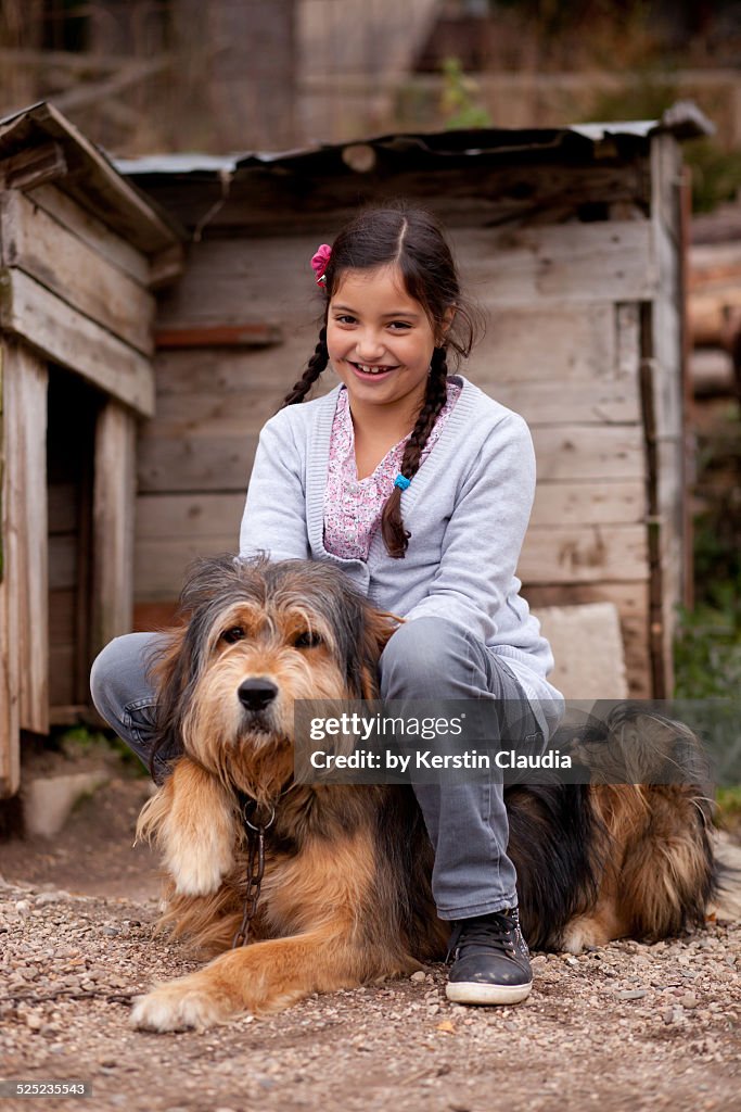 Smiling girl sitting on a dog