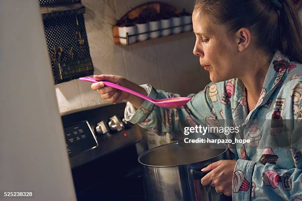 woman in pajamas cooking. - taste test stock pictures, royalty-free photos & images