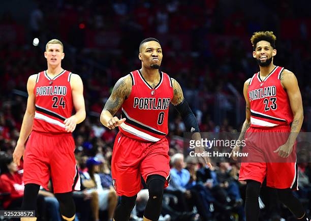 Damian Lillard of the Portland Trail Blazers reacts as he heads to the bench with Mason Plumlee and Allen Crabbe leading the Los Angeles Clippers...