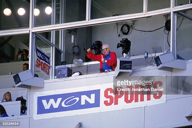 Chicago Cubs baseball announcer and Baseball Hall of Fame inductee Harry Caray conducts fans singing "Take Me Out to the Ball Game" from his...