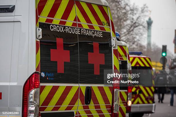 Ambulances and police officers gather in front of the offices of the French satirical newspaper Charlie Hebdo on January 7, 2015 in Paris, France....