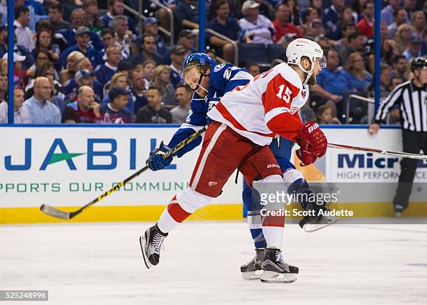 Erik Condra of the Tampa Bay Lightning is checked by Riley Sheahan of the Detroit Red Wings during the third period of Game Five of the Eastern...