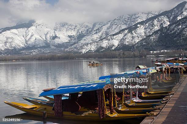 Snow capped Zabarvan mountains are reflected in Dal lake on March 10, 2015 in Srinagar, the summer capital of Indian administered Kashmir, India....