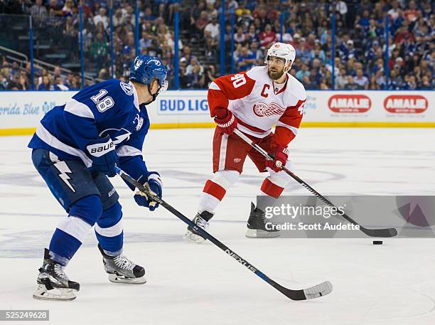 Ondrej Palat of the Tampa Bay Lightning defends against Henrik Zetterberg of the Detroit Red Wings during the second period of Game Five of the...