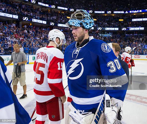 Goalie Ben Bishop of the Tampa Bay Lightning shakes the hand of Riley Sheahan of the Detroit Red Wings after Game Five of the Eastern Conference...