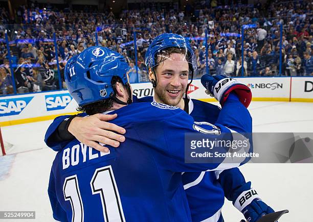 Victor Hedman and Brian Boyle of the Tampa Bay Lightning celebrate the series win against the Detroit Red Wings after Game Five of the Eastern...