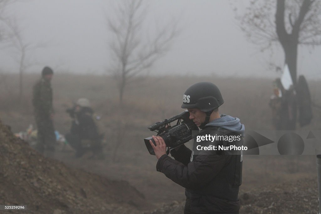 Journalists work at a frontline in Ukraine