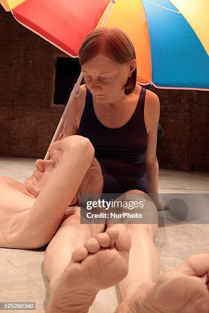 The sculpture entitled &quot;Couple Under Umbrella&quot; by the Australian artist Ron Mueck is displayed during his exhibition at the Pinacoteca of...