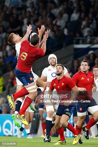 England's Henry Slade leaps for the high ball with France's Louis Picamoles during the QBE International match between England and France at...