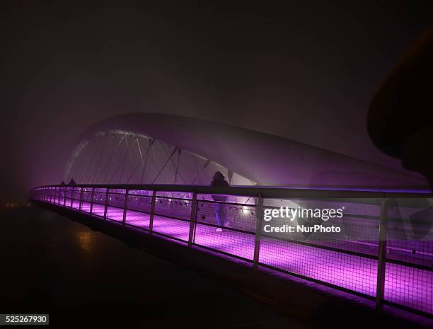 Foggy night view of the Father Bernatka Footbridge on 29th October 2014 in Krakow. Krakow's Father Bernatka Footbridge is a footbridge for...