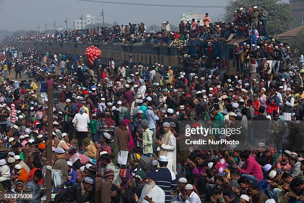 Bangladeshi Muslim devotees board trains after attending the Akheri Munajat concluding prayers on the third day of Biswa Ijtema, the second largest...