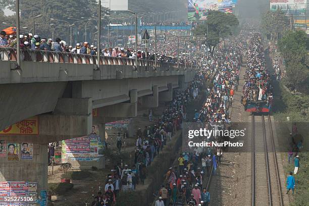 Bangladeshi Muslim devotees board trains after attending the Akheri Munajat concluding prayers on the third day of Biswa Ijtema, the second largest...