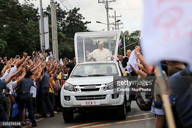 Pope Francis waves to the faithful upon his arrival at Manila Cathedral on January 16, 2015 in Manila, Philippines. Pope Francis will visit venues...