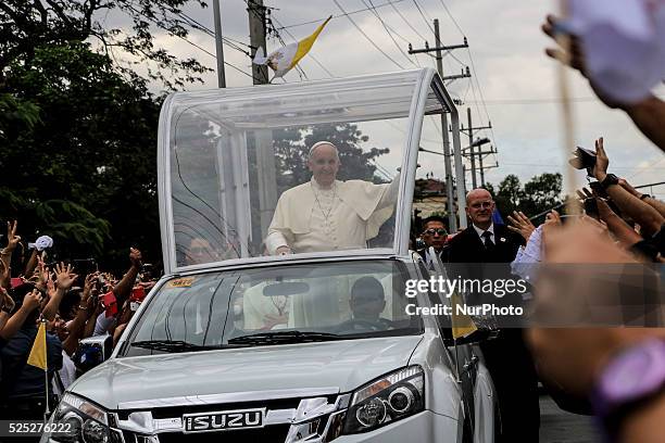 Pope Francis waves to the faithful upon his arrival at Manila Cathedral on January 16, 2015 in Manila, Philippines. Pope Francis will visit venues...