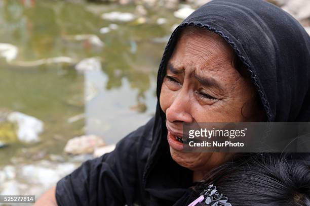 Bangladeshi relatives of victims of Rana Plaza, cry as they gather at the spot on the second anniversary of the garment factory building collapse in...