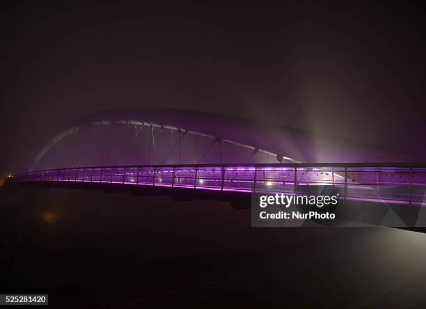 Foggy night view of the Father Bernatka Footbridge on 29th October 2014 in Krakow. Krakow's Father Bernatka Footbridge is a footbridge for...