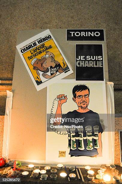 'Je suis Charlie' signs are held up at a rally and vigil in Turin's Piazza Castello, on January 9, 2015 to express solidarity with the victims of...