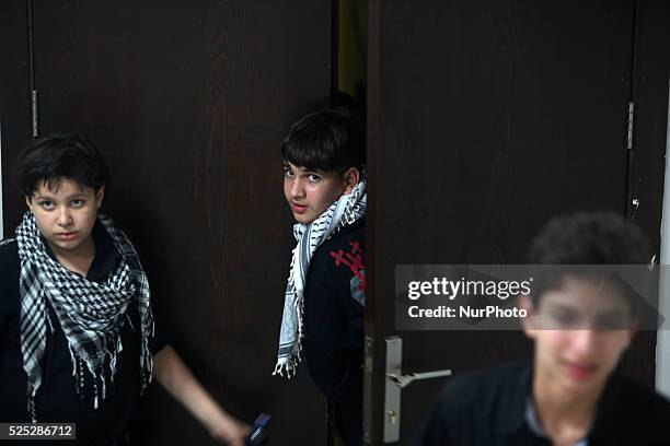 Palestinians boy looks on as she watch members of musical band from ''Edward Said National Conservatory of Music'' perform in a festival of ''Sea and...