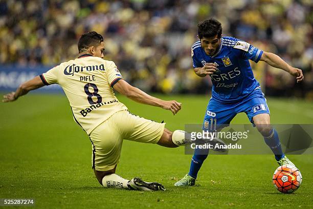 Andres Andrade of Club America struggles for the ball with Damian Alvarez of Tigres during the second leg of the final match of the CONCACAF...