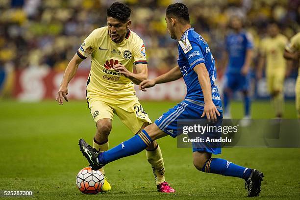Oribe Peralta of Club America struggles for the ball with Israel Jimenez of Tigres during the second leg of the final match of the CONCACAF Champions...