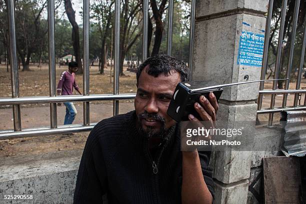 Bangladeshi man is listening to the radio as today was the first group match to the radio commentry of ICC Cricket World Cup 2015 for Bangladesh at...