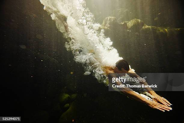 man diving into river underwater view - 思い切って飛び込む ストックフォトと画像