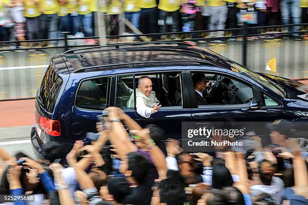 Pope Francis waves to the crowd after conducting mass in Manila on January 18, 201. Pope Francis is visiting venues across Leyte and Manila during...