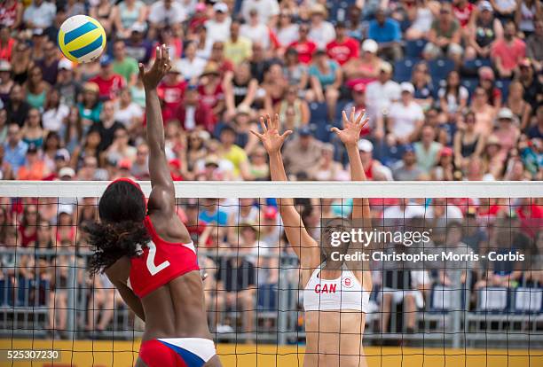 Taylor Pischke of Canada attempts a block against Leila Martinez of Cuba during Canada vs. Cuba in beach volleyball competition at the 2015 PanAm...