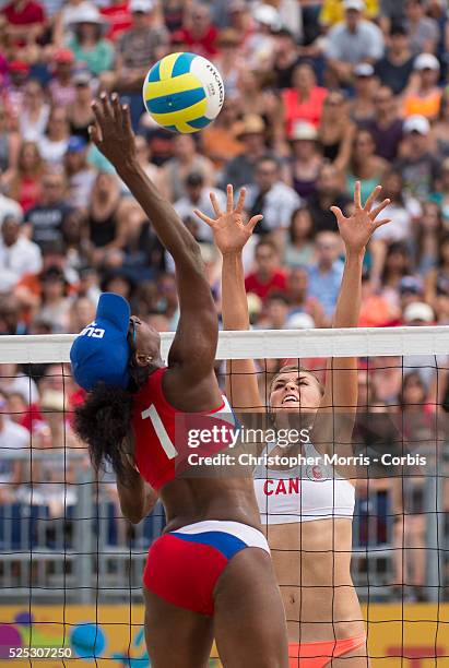 Taylor Pischke of Canada attempts a block against Leila Martinez of Cuba during Canada vs. Cuba in beach volleyball competition at the 2015 PanAm...