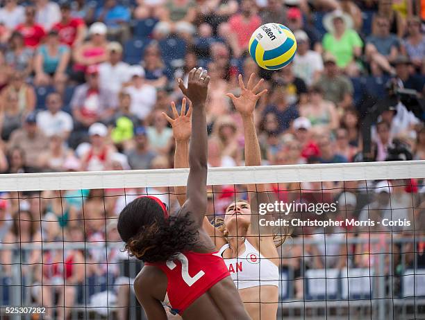 Taylor Pischke of Canada attempts a block against Leila Martinez of Cuba during Canada vs. Cuba in beach volleyball competition at the 2015 PanAm...