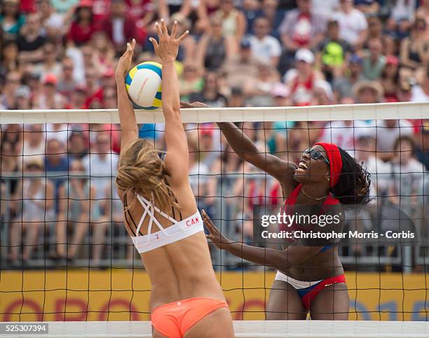 Taylor Pischke of Canada blocks a spike from Leila Martinez of Cuba during Canada vs. Cuba in beach volleyball competition at the 2015 PanAm Games in...