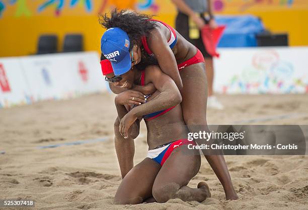 Lianma Flores and Leila Martinez of Cuba celebrate their victory during Canada vs. Cuba in beach volleyball competition at the 2015 PanAm Games in...