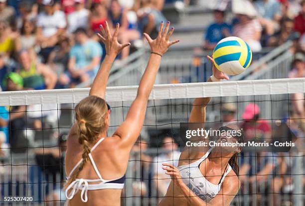 Ana Gallay of Argentina spikes the ball past Kelley Larsen of the USA during beach volleyball competition between USA and Argentina at the 2015 PanAm...