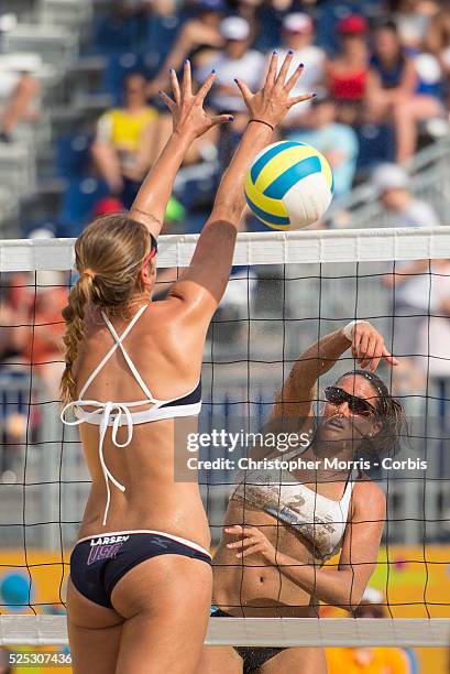 Ana Gallay of Argentina spikes the ball past Kelley Larsen of the USA during beach volleyball competition between USA and Argentina at the 2015 PanAm...