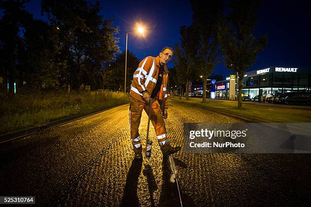 The Netherlands - Part of the entrance road to the university city is given a new top layer of asphalt. Such work is increasingly being done at...