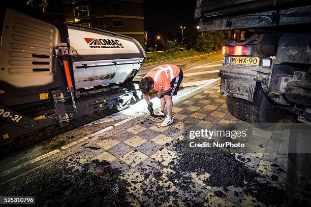 The Netherlands - Part of the entrance road to the university city is given a new top layer of asphalt. Such work is increasingly being done at...