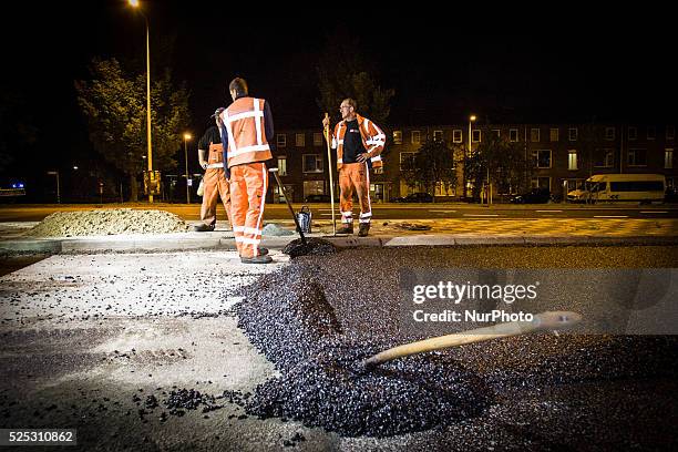 The Netherlands - Part of the entrance road to the university city is given a new top layer of asphalt. Such work is increasingly being done at...