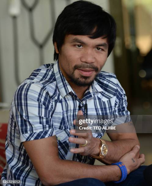 Philippine boxing legend Manny Pacquiao gestures during an interview at his residence in Manila on April 28, 2016. - Pacquiao expressed shock on...