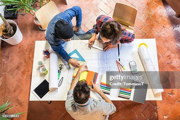 architects at work studying a blueprint - sorting hat stock pictures, royalty-free photos & images