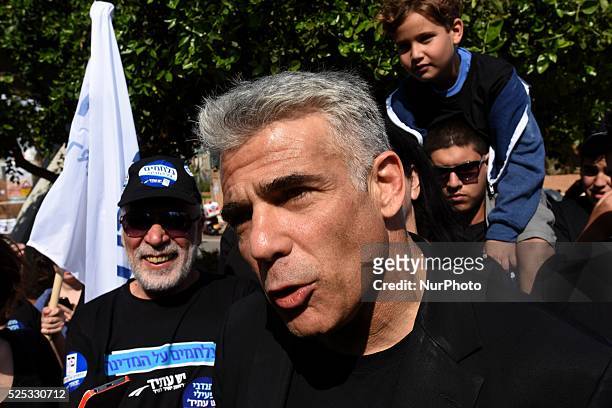 Yair Lapid, leader of 'Yesh Atid' Party and former Israeli Finance Minister talks to supporters during a visit to a polling station in Ra'anana,...
